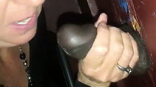 Wife sucks 2 BBCs at the gloryhole
